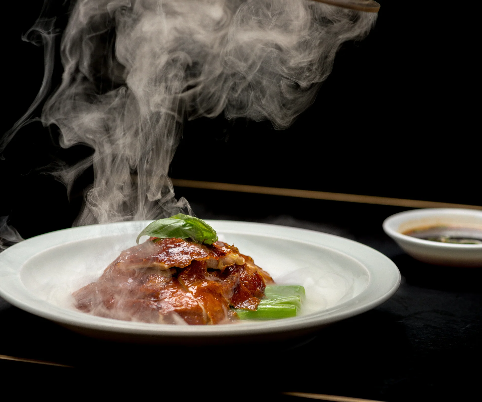 Retouched Hakkasan duck dish with steam